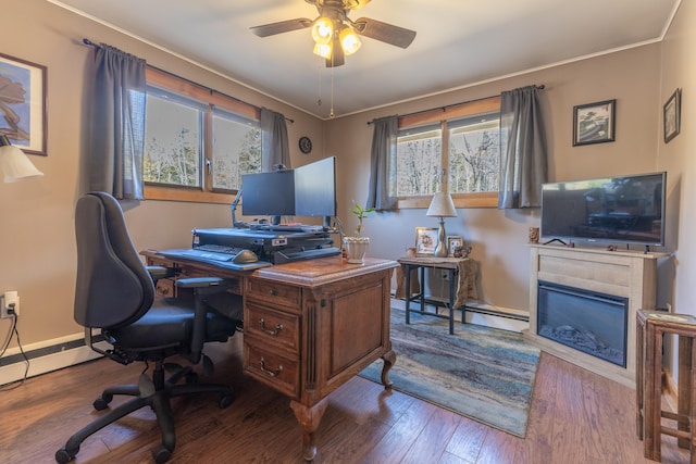 office space featuring plenty of natural light, baseboards, wood finished floors, and ceiling fan