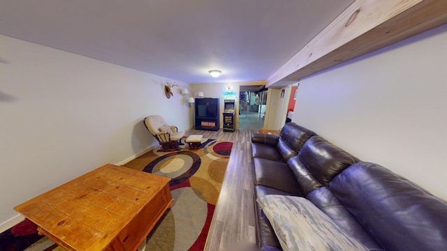 living area featuring baseboards and wood finished floors