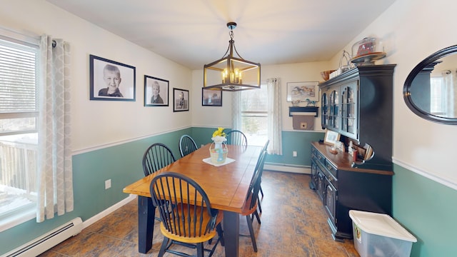 dining area featuring baseboards, a notable chandelier, and a baseboard heating unit