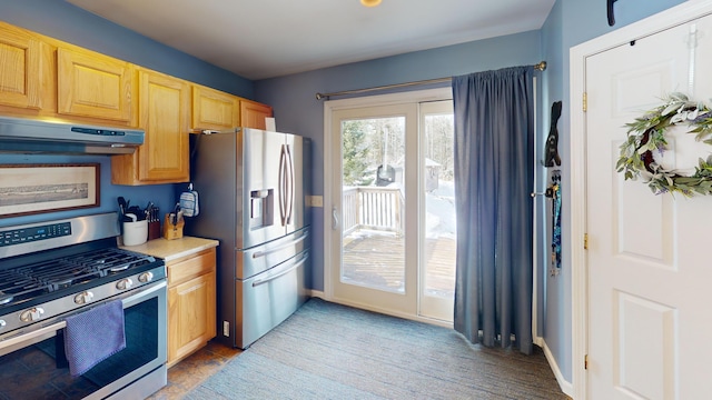 kitchen featuring light countertops, stainless steel appliances, baseboards, under cabinet range hood, and light brown cabinets