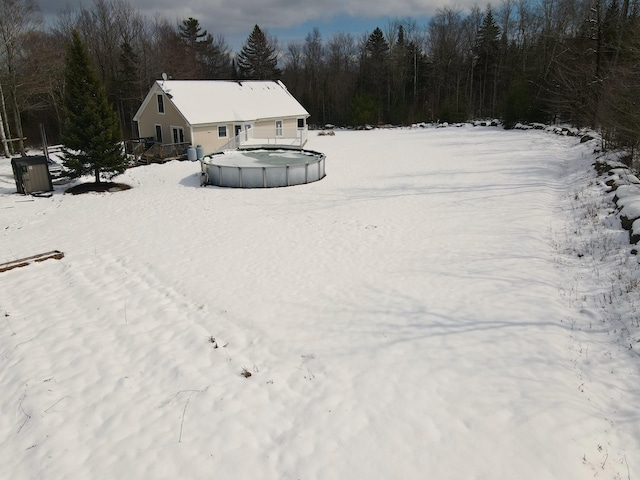 snowy aerial view with a view of trees