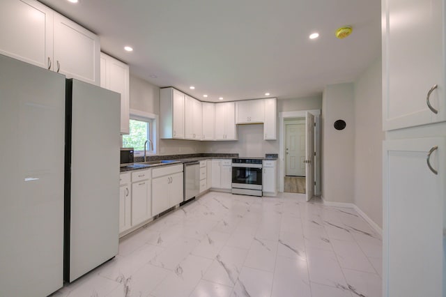 313 W Neck Rd, Nobleboro, ME 04555 - kitchen featuring stainless steel appliances, a sink, dark countertops, baseboards, and light marble finish floors