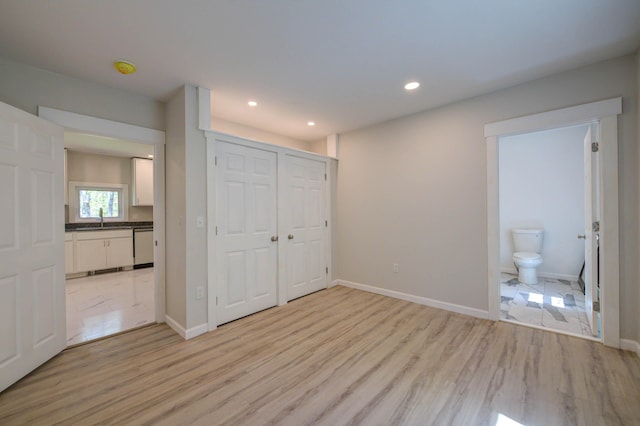 313 W Neck Rd, Nobleboro, ME 04555 - unfurnished bedroom with light wood-type flooring, recessed lighting, connected bathroom, baseboards, and a closet
