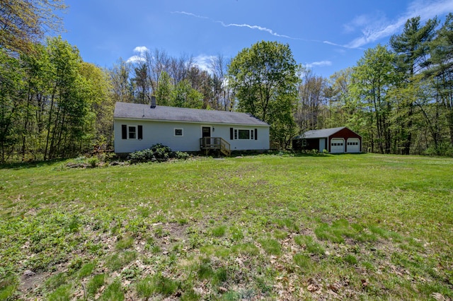 313 W Neck Rd, Nobleboro, ME 04555 - back of house featuring a garage, a yard, and an outbuilding