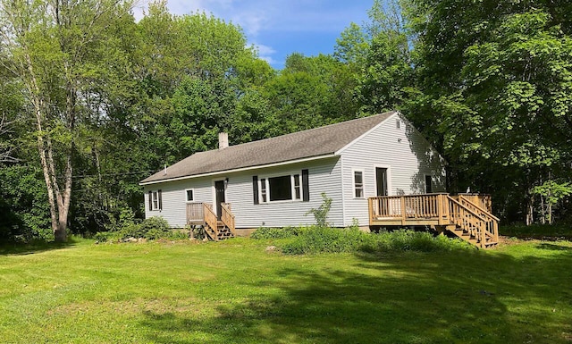 313 W Neck Rd, Nobleboro, ME 04555 - back of property with a yard, a wooden deck, a chimney, and roof with shingles