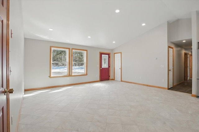 spare room featuring baseboards, recessed lighting, and lofted ceiling