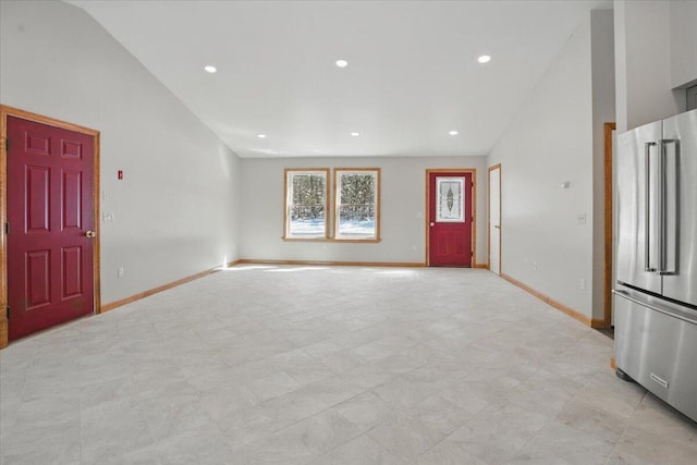 unfurnished living room with high vaulted ceiling, baseboards, and recessed lighting