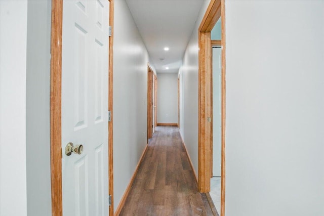 hallway with baseboards and wood finished floors