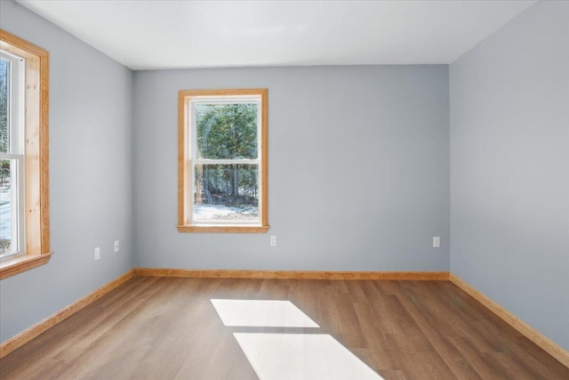 unfurnished room featuring wood finished floors and baseboards