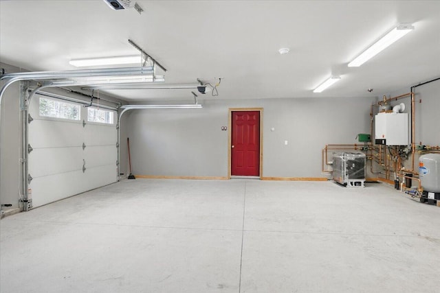 garage with water heater and a garage door opener