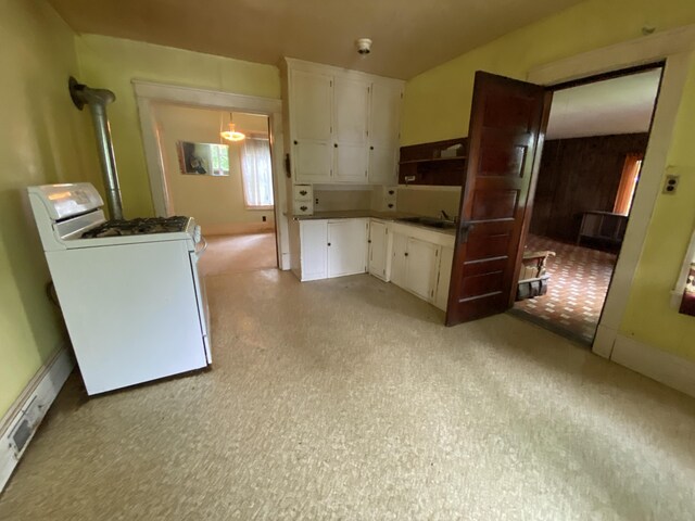 927 Van Buren Rd, Caswell, ME 04750 - kitchen with white cabinetry, washer / clothes dryer, and a sink