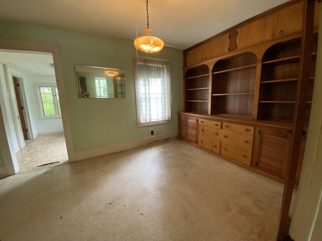 927 Van Buren Rd, Caswell, ME 04750 - unfurnished living room featuring baseboards and concrete floors