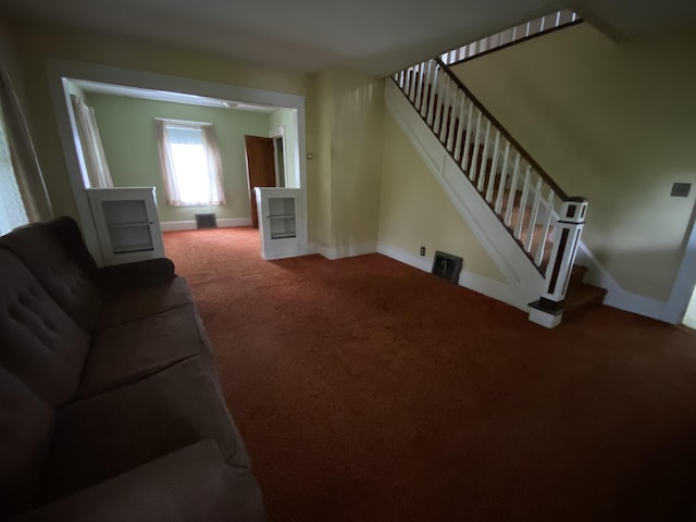 927 Van Buren Rd, Caswell, ME 04750 - carpeted living room with baseboards, stairs, and visible vents