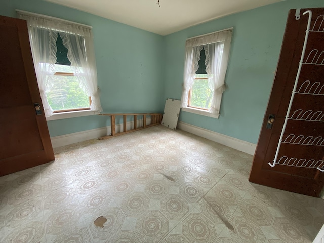 927 Van Buren Rd, Caswell, ME 04750 - unfurnished bedroom with baseboards and multiple windows