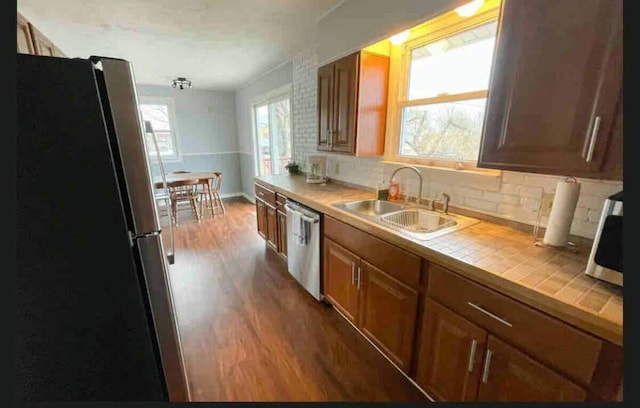 191 Water St, Eastport, ME 04631 - kitchen with a sink, stainless steel appliances, tile countertops, wood finished floors, and tasteful backsplash