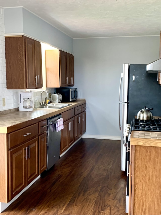 191 Water St, Eastport, ME 04631 - kitchen featuring appliances with stainless steel finishes, dark wood-style floors, a sink, and tasteful backsplash