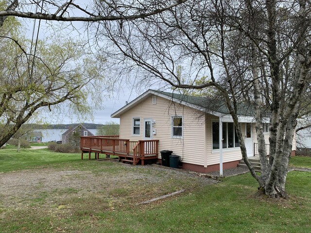 191 Water St, Eastport, ME 04631 - rear view of property with a deck and a lawn