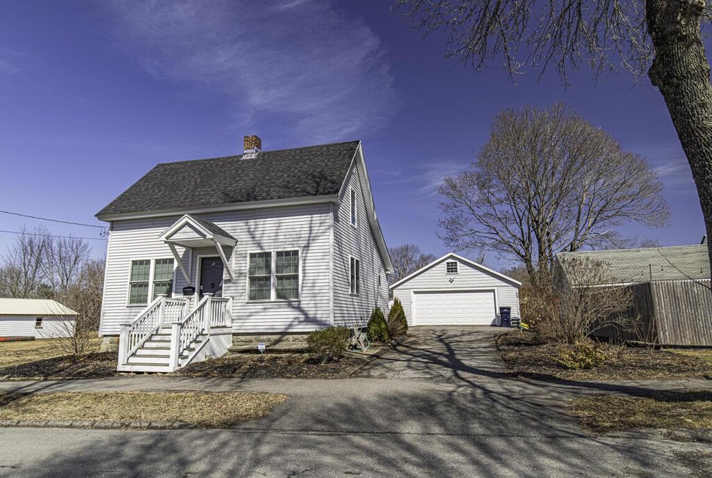 9 Vine St, Bangor, ME 04401 - view of front of house featuring a chimney, a detached garage, an outdoor structure, and roof with shingles