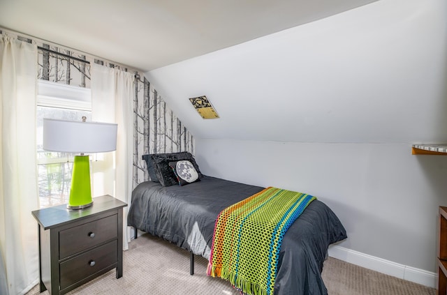 bedroom with lofted ceiling, baseboards, and carpet floors