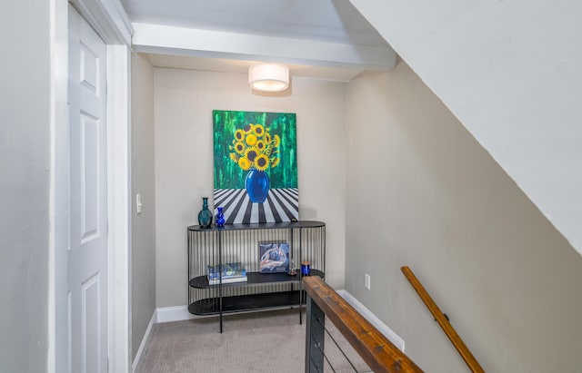 hallway with carpet and baseboards