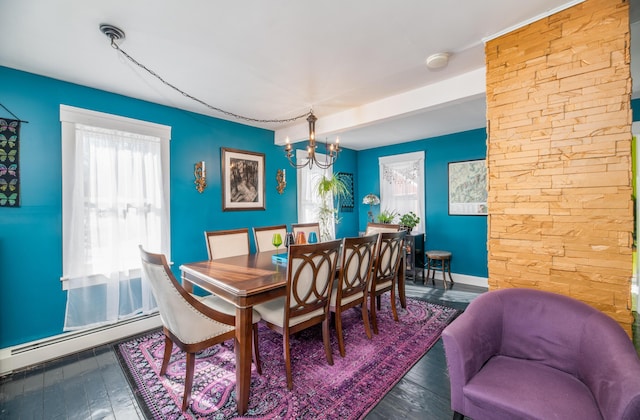 dining area featuring an inviting chandelier, hardwood / wood-style flooring, a baseboard heating unit, and baseboards