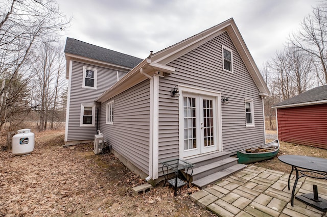 view of home's exterior with a patio area, entry steps, and french doors