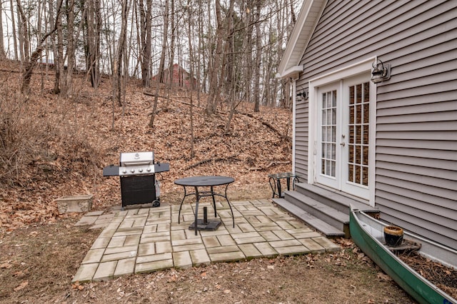 view of patio featuring french doors, entry steps, and a grill