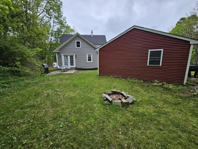 3 Adell Rd, Readfield, ME 04355 - rear view of property with an outdoor fire pit, a lawn, a patio, and french doors