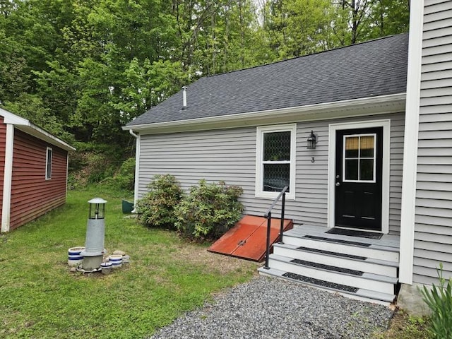 3 Adell Rd, Readfield, ME 04355 - doorway to property featuring a shingled roof and a lawn