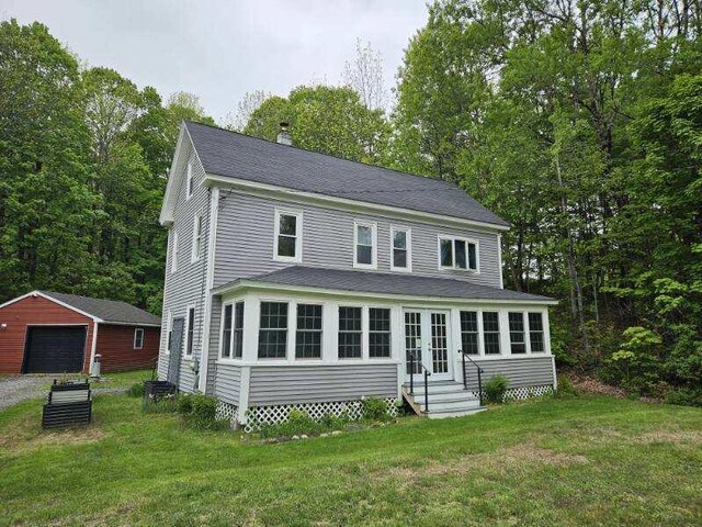 3 Adell Rd, Readfield, ME 04355 - view of front of property with entry steps, a garage, a chimney, a front yard, and an outdoor structure