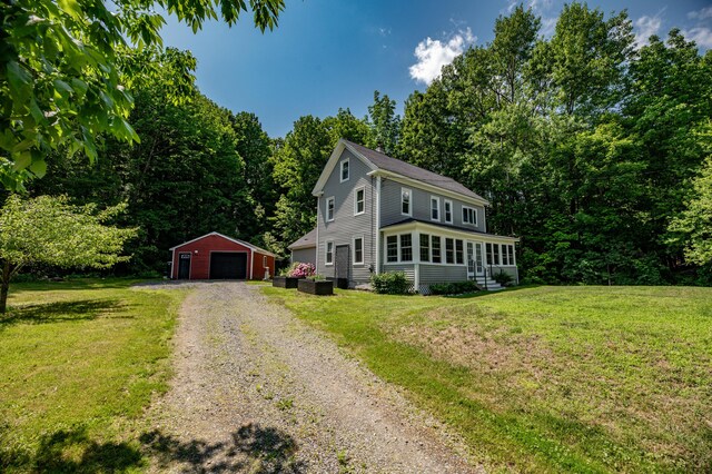 3 Adell Rd, Readfield, ME 04355 - view of front of home featuring an outdoor structure, driveway, a garage, and a front yard