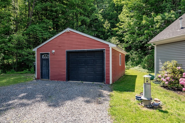 3 Adell Rd, Readfield, ME 04355 - detached garage with driveway and a view of trees