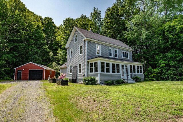 3 Adell Rd, Readfield, ME 04355 - view of front of house with entry steps, an outdoor structure, a garage, driveway, and a front lawn