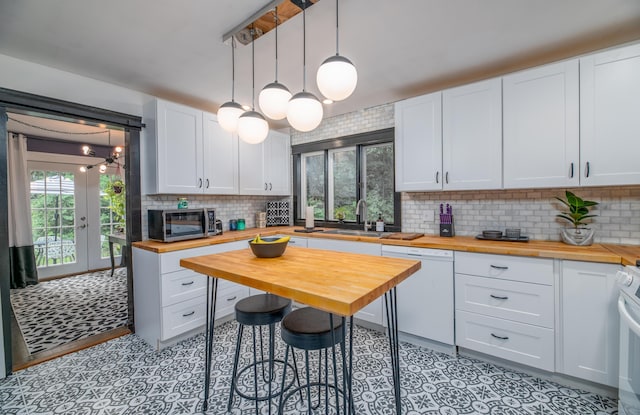 3 Adell Rd, Readfield, ME 04355 - kitchen with wood counters, white appliances, decorative backsplash, white cabinets, and decorative light fixtures