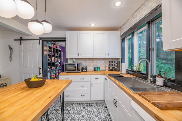 3 Adell Rd, Readfield, ME 04355 - kitchen with butcher block countertops, stainless steel microwave, white cabinetry, backsplash, and recessed lighting