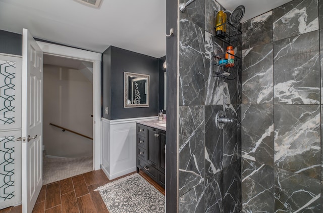 3 Adell Rd, Readfield, ME 04355 - full bath featuring wood finish floors, a tile shower, vanity, and wainscoting