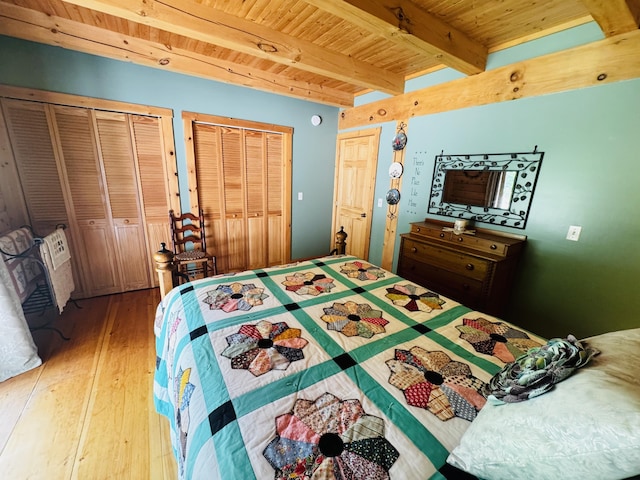 362 N Raymond Rd, Poland, ME 04274 - bedroom featuring a wood ceiling with exposed beams, two closets, and hardwood / wood-style floors