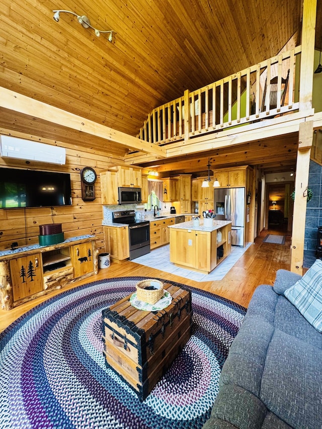 362 N Raymond Rd, Poland, ME 04274 - living room with high vaulted ceiling, wood walls, light wood-type flooring, wood ceiling, and track lighting