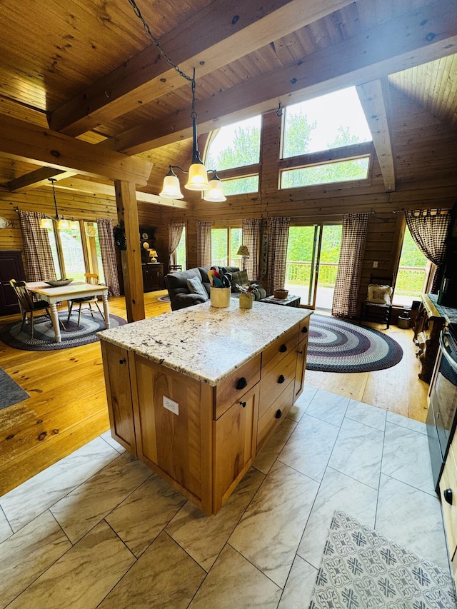 362 N Raymond Rd, Poland, ME 04274 - kitchen featuring a wooden ceiling with exposed beams, light stone counters, pendant lighting, brown cabinets, and open floor plan
