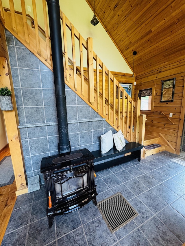 362 N Raymond Rd, Poland, ME 04274 - living area with a wood stove, wood ceiling, lofted ceiling, wood walls, and tile patterned flooring