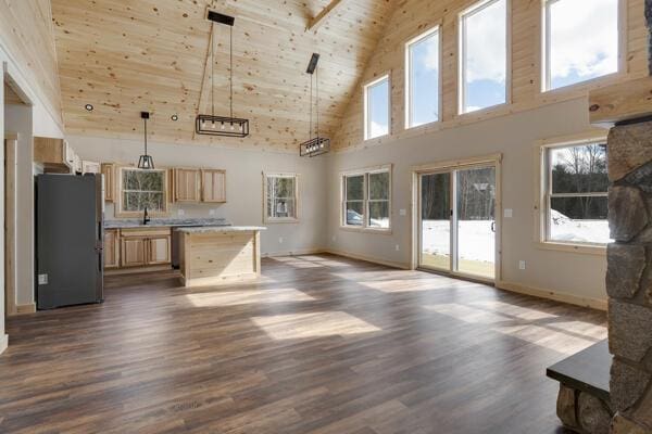 18 Thayer Way, Bethel, ME 04217 - kitchen featuring freestanding refrigerator, high vaulted ceiling, open floor plan, dark wood-type flooring, and light countertops