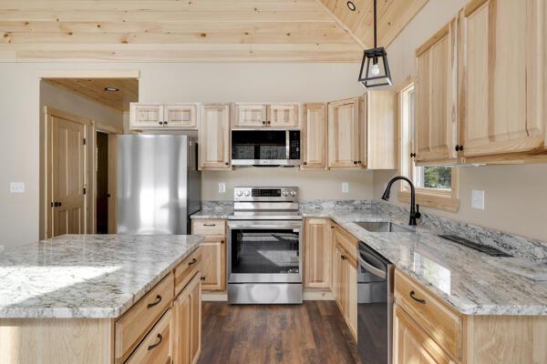 18 Thayer Way, Bethel, ME 04217 - kitchen featuring appliances with stainless steel finishes, light brown cabinetry, and dark wood finished floors