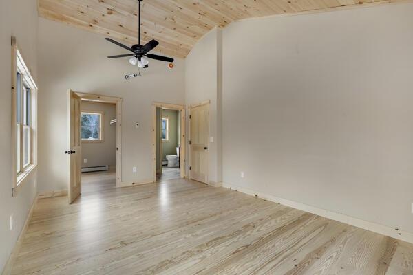 18 Thayer Way, Bethel, ME 04217 - unfurnished room with baseboard heating, lofted ceiling, light wood finished floors, wood ceiling, and ceiling fan