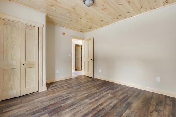 18 Thayer Way, Bethel, ME 04217 - unfurnished bedroom featuring wood finished floors, a closet, and wooden ceiling