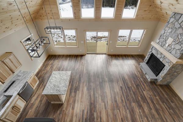 18 Thayer Way, Bethel, ME 04217 - unfurnished living room featuring high vaulted ceiling, a fireplace, wood finished floors, and wood ceiling