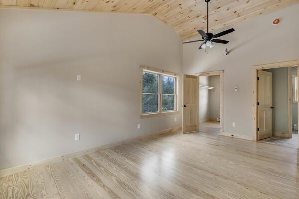 18 Thayer Way, Bethel, ME 04217 - unfurnished bedroom featuring wooden ceiling, light wood finished floors, a ceiling fan, and high vaulted ceiling