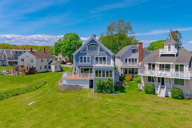 7 Pier Rd Unit 7, Kennebunkport, ME 04046 - back of property featuring a balcony, a residential view, and a lawn