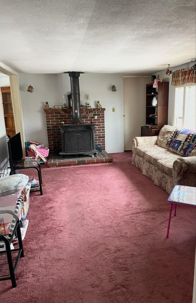 101 Gurney St, Rockport, ME 04856 - living area featuring carpet flooring, a textured ceiling, and a wood stove