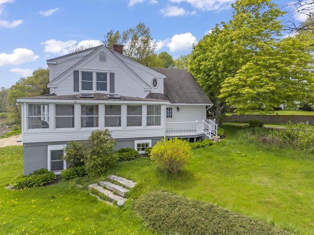 15 Church Ln, Phippsburg, ME 04562 - back of house featuring a chimney, roof with shingles, a sunroom, and a lawn