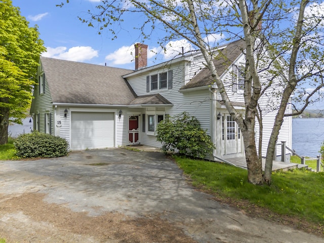 15 Church Ln, Phippsburg, ME 04562 - traditional home featuring an attached garage, asphalt driveway, a chimney, and a shingled roof